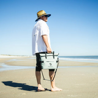 Man carrying Dry Pocket cooler on the beach