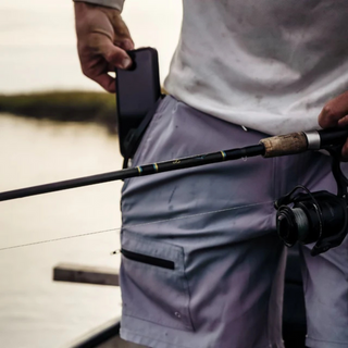 Man fishing with Dry Pocket waterproof pocket shorts