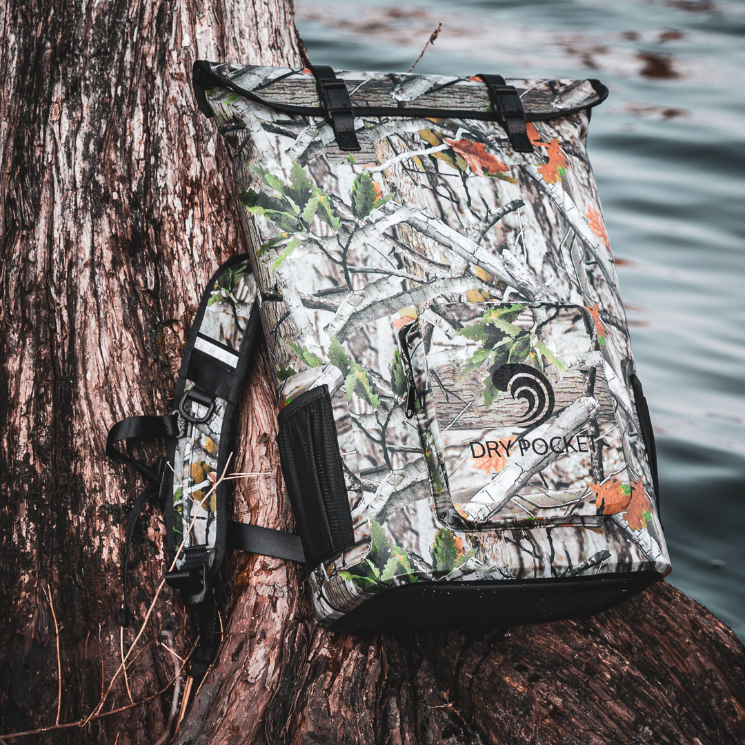 Dry Pocket forest camo magnetic auto-sealing, waterproof, scent proof, and floating 18 can backpack cooler that can also act as a waterproof dry bag. 