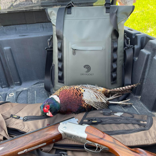 Dry Pocket hunter green magnetic auto-sealing, waterproof, scent proof, and floating 18 can tote cooler that can also act as a dry bag. 