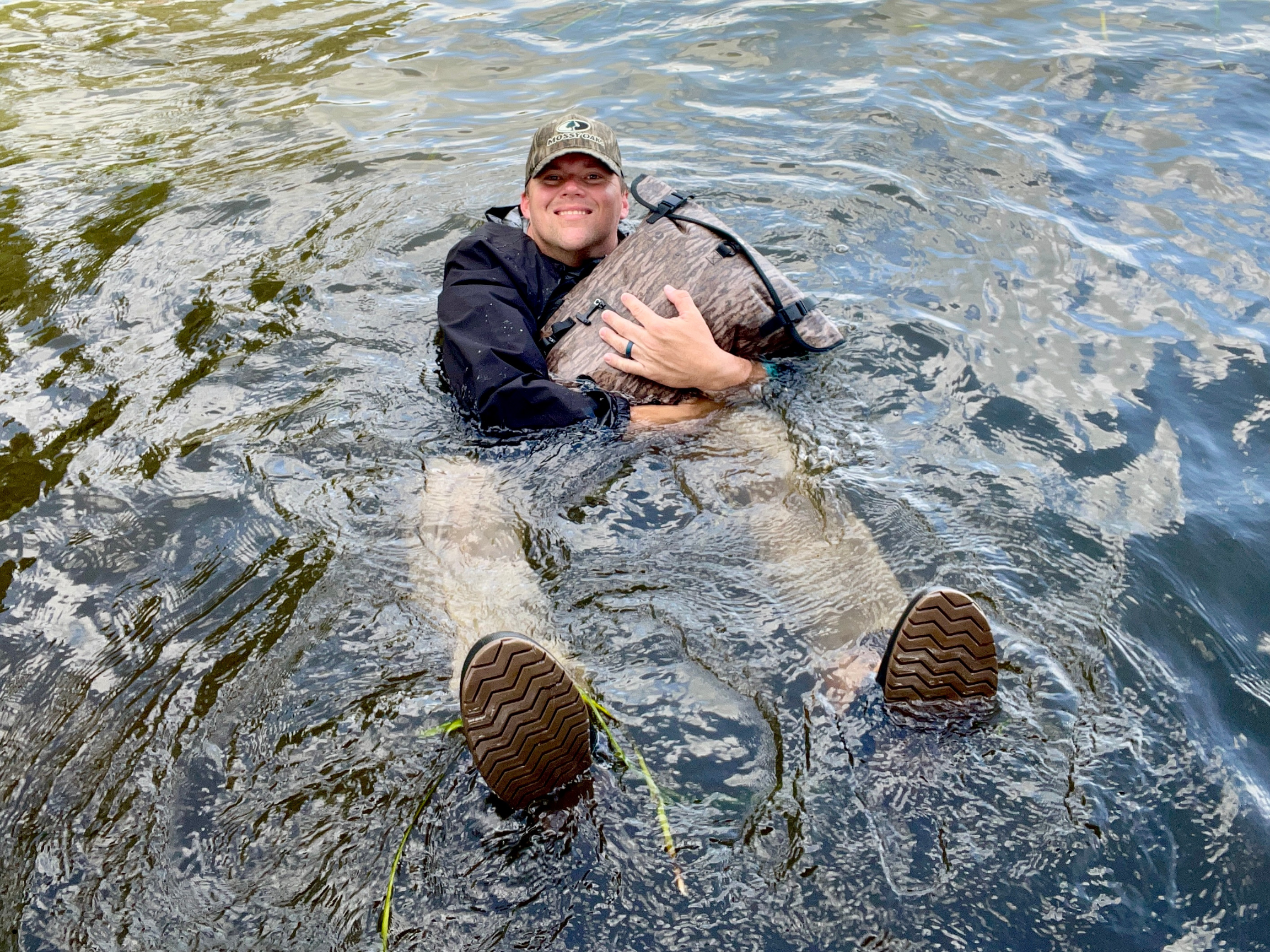 Man floating on a Dry Pocket waterproof backpack dry bag