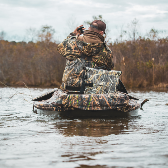 Dry Pocket's Mossy Oak Camouflage-patterned universal waterproof, scent proof, and floating magnetic double lock auto-sealing 10 can tote cooler and dry bag with a shoulder strap on a white background