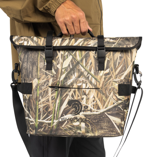 Dry Pocket's Mossy Oak Camouflage-patterned universal waterproof, scent proof, and floating magnetic double lock auto-sealing 10 can tote cooler and dry bag with a shoulder strap on a white background