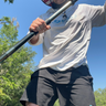 Man on paddle board wearing Dry Pocket's waterproof shorts with a waterproof pocket. 