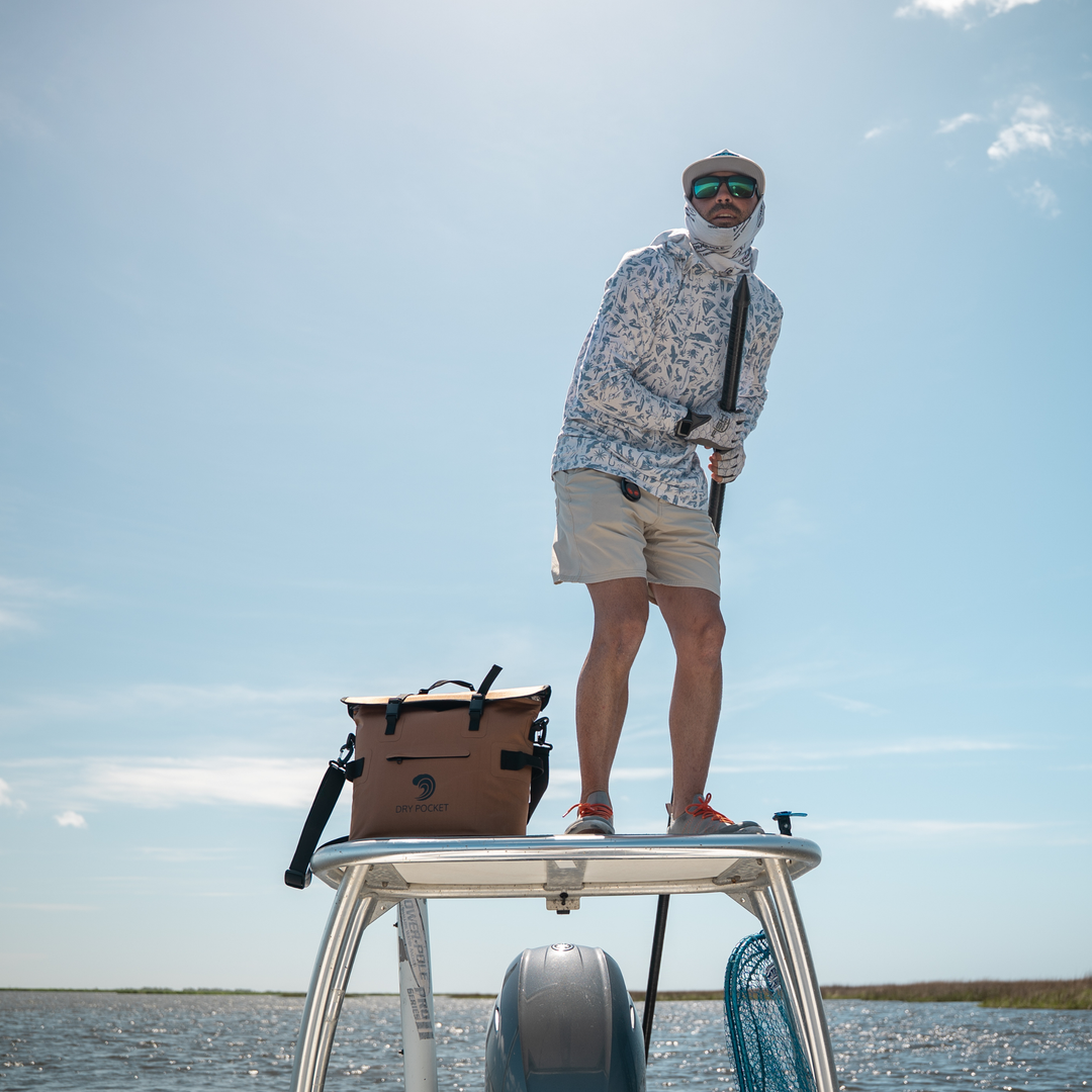 Man fishing on boat with a Dry Pocket Cooler