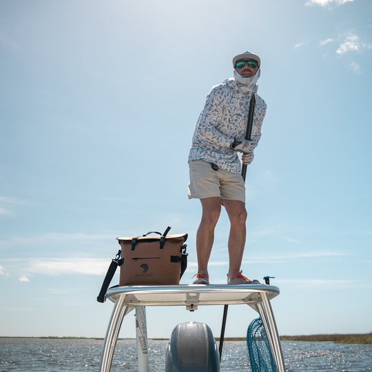 Man fishing on boat with a Dry Pocket Cooler