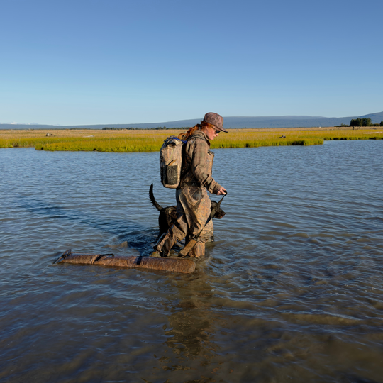 Woman hunting in the water with a Dry Pocket shotgun bag 